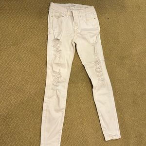 Frame white jeans with rips along the leg in front designed